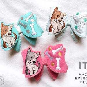 May include: Three machine embroidery designs featuring a dog with bones. The designs are in turquoise, pink and white.