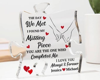May include: A clear acrylic puzzle piece shaped like a heart with the text "The day we met I found my missing piece You are the one who completes me I love you Always & Forever Jessica Michael" and red hearts.