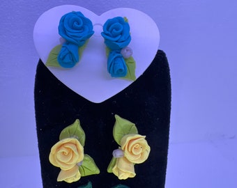 Handmade clay rose studs with a rose and rose bud on leaves. Comes in multiple colors.