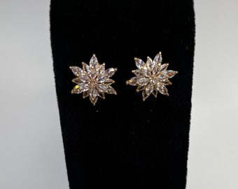 Clear rhinestone starburst earrings in a gold casing