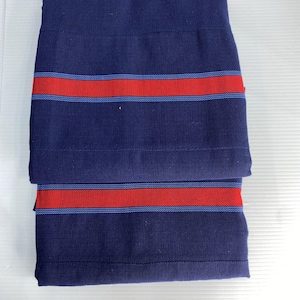 May include: Two pieces of blue fabric with red and blue stripes. The fabric is folded in half.