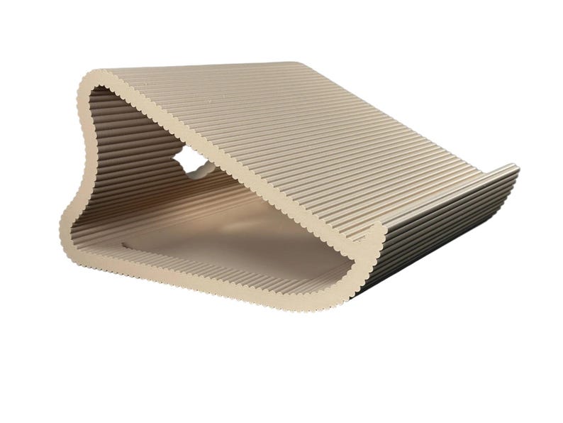 Pu&ograve; includere: Un supporto per computer portatile color beige con un profilo triangolare curvo e cavo, caratterizzato da una superficie scanalata e testurizzata. La struttura presenta un piccolo intaglio circolare sul lato e un bordo anteriore.