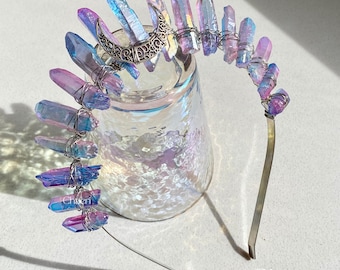May include: A silver crescent moon charm headband with iridescent purple and blue crystal points wrapped in silver wire.