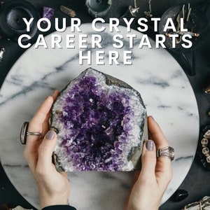 May include: A large amethyst crystal geode with a purple interior, held in hands against a white marble background. The text "YOUR CRYSTAL CAREER STARTS HERE" is displayed above the geode.