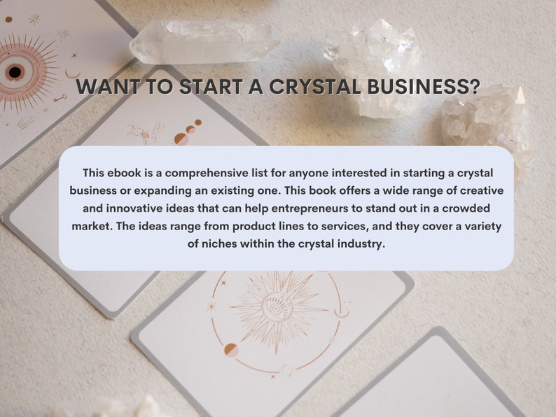 May include: A light blue and white text box with the text "WANT TO START A CRYSTAL BUSINESS?" in black text. The text box is on top of a white background with a crystal and a card with a sun and moon design.