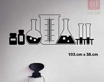 May include: A black wall decal featuring a collection of laboratory glassware including two small bottles, a round-bottom flask, a large graduated cylinder, an Erlenmeyer flask, and two test tubes in a rack. The text 103.cm x 38.cm is visible.