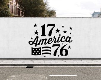 May include: A black graphic design featuring the large number 17, the word America in a cursive script, and the number 76. The design includes a small American flag icon and multiple five-pointed stars arranged around the text and numbers.