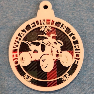 May include: White Christmas bauble with a red and black tartan pattern. The bauble features a silhouette of a quad bike with the text "Oh What Fun It Is To Ride".