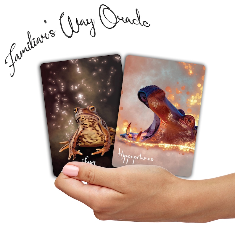 May include: Two oracle cards with a brown toad and a hippopotamus. The toad card has a dark background with gold sparkles and the text "Toad". The hippopotamus card has a light background with gold sparkles and the text "Hippopotamus".