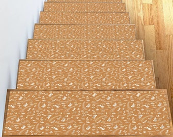 May include: A set of brown stair treads with a white floral pattern. The treads are designed to add grip and style to stairs.