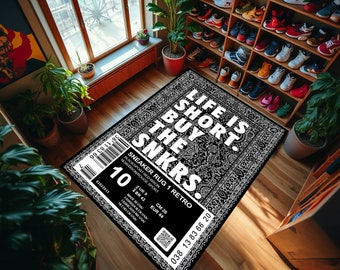 May include: Black and white patterned rug with the text "Life is short. Buy the SNKRS."  The rug has a tag with the text "Sneaker Rug 1 Retro" and details about the rug's size and origin.