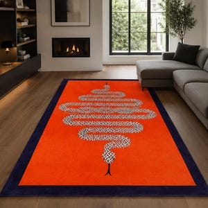 May include: A rectangular area rug featuring a vibrant orange field with a dark navy blue border. Centered on the rug is a large, stylised snake graphic in a white and grey patterned design, oriented vertically with its head pointing downwards.