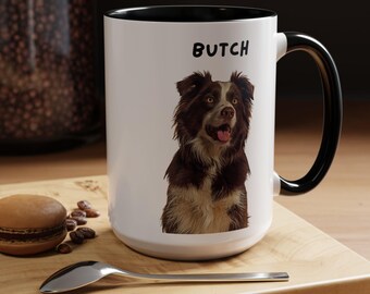 May include: White ceramic mug with a black rim and handle. The mug features a brown and white border collie dog with the name "Butch" printed in black text.