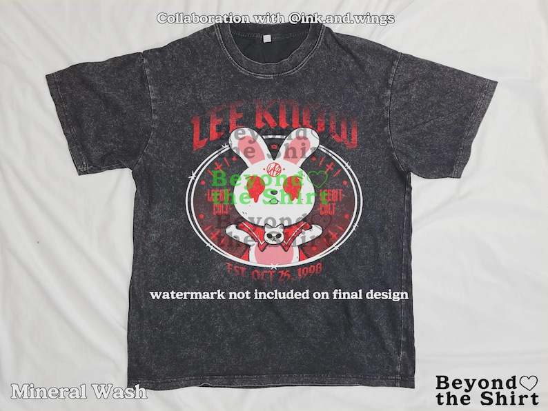 May include: Dark gray mineral wash t-shirt featuring a cartoon rabbit design with the text "LEE KNOW" in red. The rabbit has strawberry eyes and a red bow tie. The shirt also includes the text "EST. OCT 25, 1998".