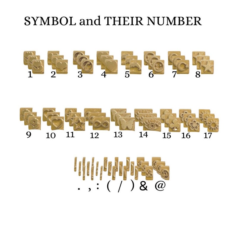 May include: A set of 17 gold-toned metal stamps with various symbols and punctuation marks. The stamps are arranged in rows and numbered 1 through 17. The symbols include a heart, a star, an infinity symbol, a butterfly, an eye, a clover, a flower, and a sun. The punctuation marks include a period, a comma, a colon, a parenthesis, a slash, an ampersand, and an at symbol.