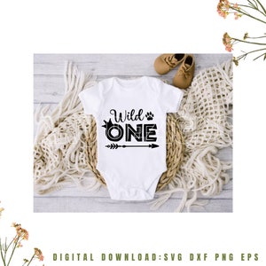 May include: White baby onesie with black text that reads "Wild One" with a crown and paw print above the word "One" and an arrow below.