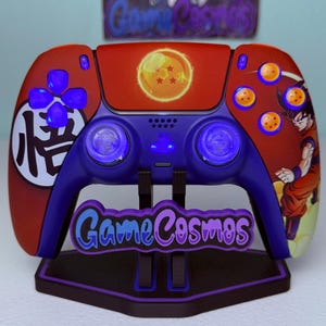 以下が含まれることがあります： スタンド付きのカスタム赤と青のビデオゲームコントローラー。 コントローラーは、キャラクターグラフィック、青く光るボタン、およびテキスト「Game Cosmos」を備えたドラゴンボールZテーマを特徴としています。