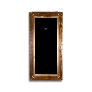 May include: A dark wood picture frame with a black background and a gold trim. The frame has decorative metal accents in the corners.