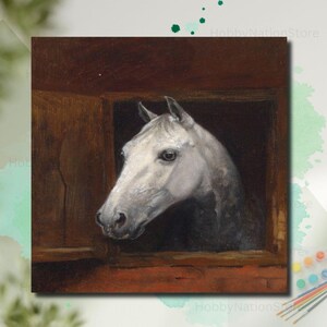 May include: A painting of a white horse's head and neck, looking out of a wooden stable window. The horse has a grey mane and a dark eye. The artwork is framed in a dark brown wooden frame.