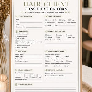 May include: A hair client consultation form on a clipboard, measuring 21.59 cm by 27.94 cm. The document includes sections for client information, service requested, hair history, concerns, goals, lifestyle, stylist assessment, and a signature agreement.