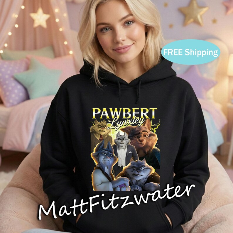 以下が含まれることがあります： 黒いフード付きスウェットシャツ。擬人化されたオオヤマネコのキャラクターのグラフィックと、黄色の「PAWBERT Lynxley」の文字が特徴です。スウェットシャツには、白い文字で「MattFitzwater」も書かれています。