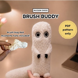 May include: A white plush toy with a long tail, black embroidered eyes, and small black hands. Text reads: MAISON EMIRI BRUSH BUDDY, brush bug dad mustache tuto included!, and PDF pattern only. The toy has a fuzzy texture and stands upright.