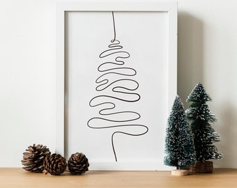 May include: A framed minimalist art print featuring a black line drawing of a Christmas tree. The artwork is displayed with miniature green Christmas trees and pine cones on a wooden surface, creating a festive holiday scene.