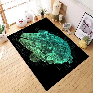 May include: A black and green area rug featuring a detailed diagram of the Millennium Falcon spaceship from Star Wars. The diagram includes labels for different parts of the ship.