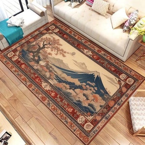 May include: A traditional Japanese-style rug with a detailed illustration of Mount Fuji and cherry blossoms. The rug has a red, blue, and gold border with intricate patterns.