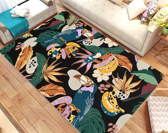 May include: A black area rug with a tropical design featuring toucans, bananas, and palm leaves in shades of green, yellow, orange, pink, and blue.
