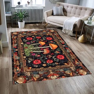 May include: A black and gold rug with a floral pattern and three orange mushrooms in the center. The rug has a vintage, ornate border.