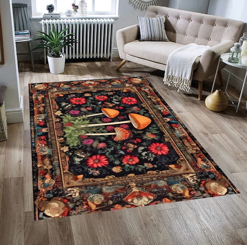May include: A black and gold rug with a floral pattern and three orange mushrooms in the center. The rug has a vintage, ornate border.