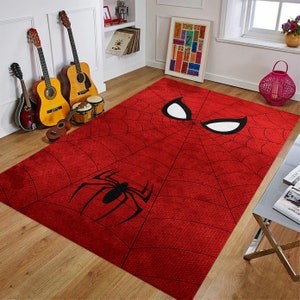 May include: Red and black area rug with a spider web design and a large white spider eye in the center. The rug has a distressed look and is perfect for a child's room or playroom.