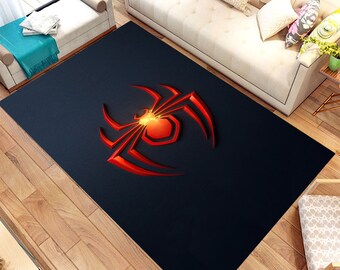 May include: A black area rug with a red 3D spider design. The spider is in the center of the rug and has a glowing orange center.