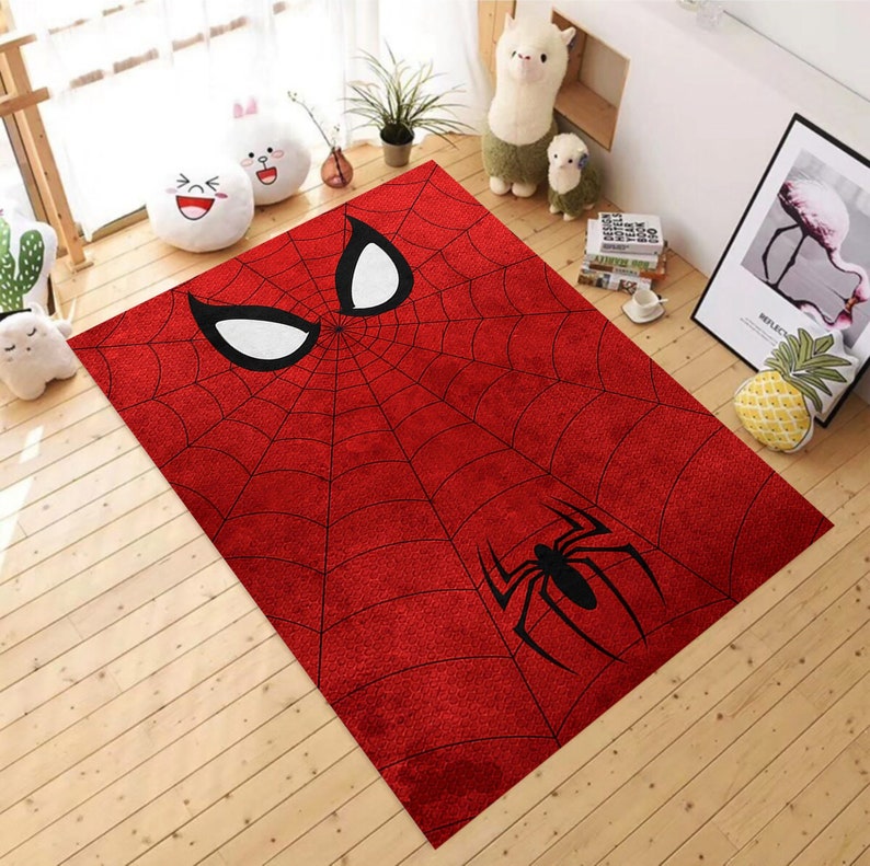 May include: Red and black area rug with a spider web design and a spider in the center. The top of the rug features a white and black Spiderman mask.
