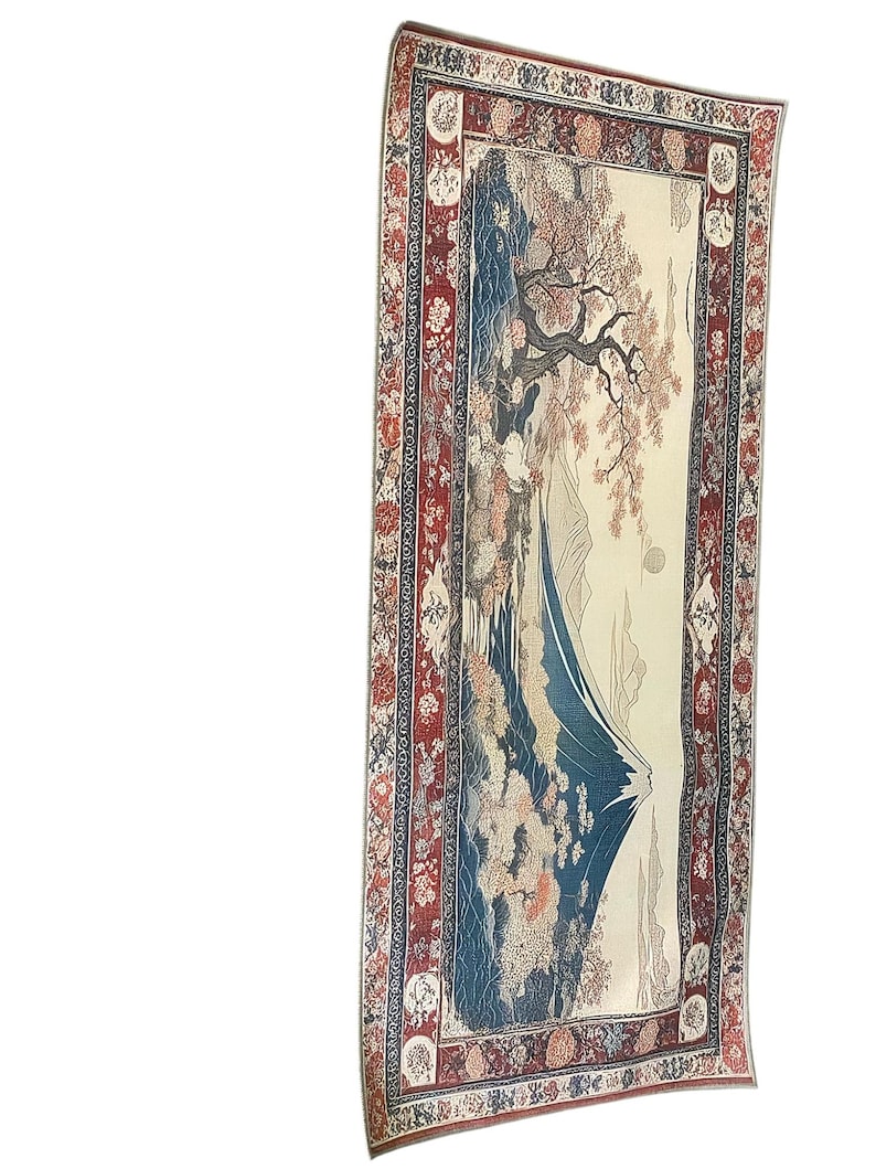 May include: A tapestry with a traditional Japanese design featuring a mountain, trees, and a river. The tapestry has a red, white, and blue border with floral patterns.