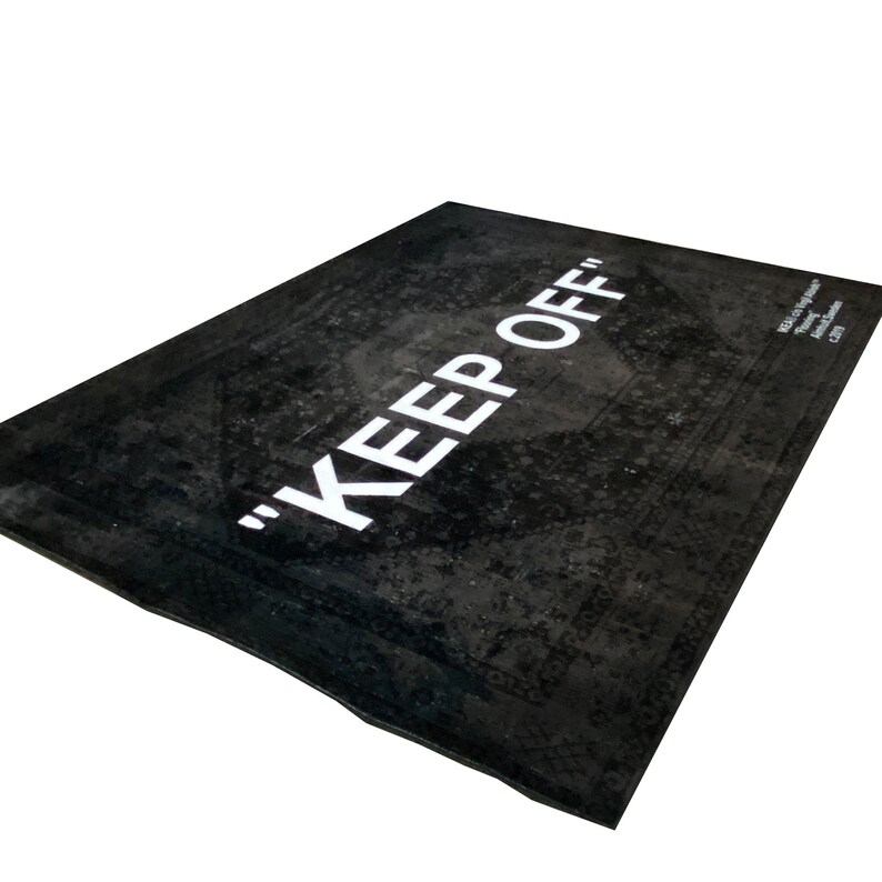 May include: Black and white rug with the text "KEEP OFF" in white lettering. The rug has a distressed, vintage look.