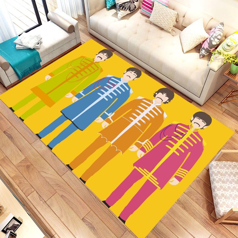 May include: A yellow rug with a graphic design of four figures wearing colorful outfits. The figures are standing in a row and have black hair and mustaches.