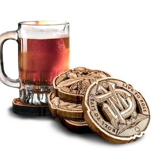 May include: A clear glass beer mug filled with amber liquid and foam, resting on a wooden coaster. Several round wooden coasters with engraved designs and the text "LIVE TO ROLL" are stacked nearby. The coasters have a natural wood finish.