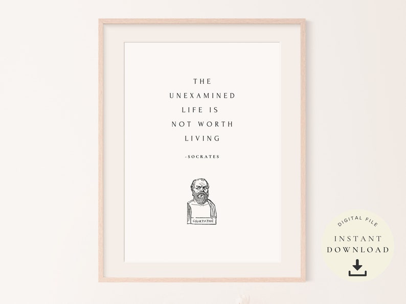 May include: A printable quote by Socrates, "The unexamined life is not worth living." The quote is in black text on a white background with a black and white illustration of Socrates below the quote. The text "Socrates" is below the illustration. The image is framed in a light wood frame.