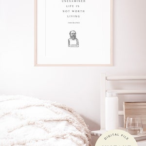 May include: A framed print with a white background and black text that reads "The unexamined life is not worth living - Socrates". A black and white illustration of Socrates is below the text.
