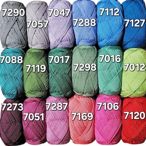 May include: A collection of colorful yarn skeins in various shades, including gray, blue, green, pink, and red. Each skein is labeled with a number. Ideal for knitting and crochet projects.