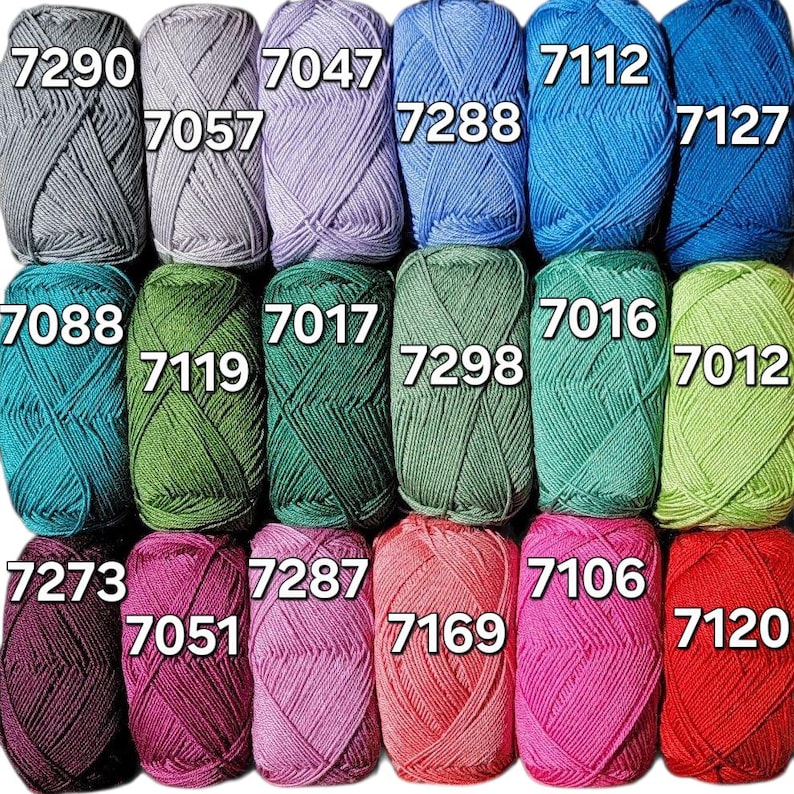May include: A collection of colorful yarn skeins in various shades, including gray, blue, green, pink, and red. Each skein is labeled with a number. Ideal for knitting and crochet projects.