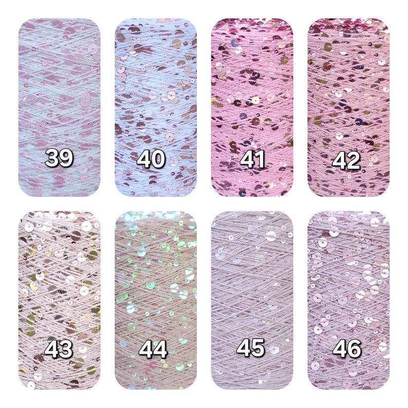 May include: Eight spools of yarn arranged in two rows, labeled 39 through 46. Each spool features a distinct shade of pink, lavender, or neutral thread interwoven with reflective, circular sequins of varying sizes and metallic finishes.
