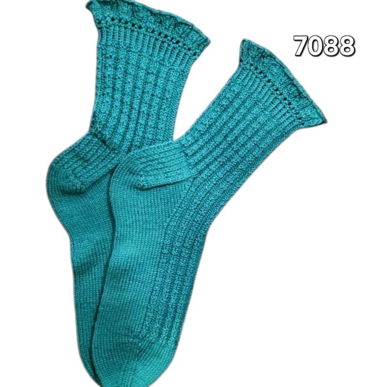 May include: A pair of teal-colored knitted socks. The socks have a ribbed pattern on the leg and foot, with a decorative scalloped edge at the top. The number "7088" is printed in the upper right corner.