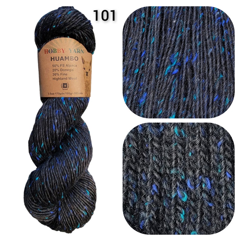 May include: A skein of Hobby Yarn Huambo, color 101, featuring a dark gray base with flecks of blue and teal. The label indicates the yarn is a blend of alpaca, Donegal, and Highland wool. The skein weighs 3.5 oz and is 175 yards long.