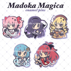 May include: Five enamel pins featuring characters from the anime series Madoka Magica. The pins are colorful and feature the characters in their signature poses. The text "Madoka Magica enamel pins" is at the top of the image.