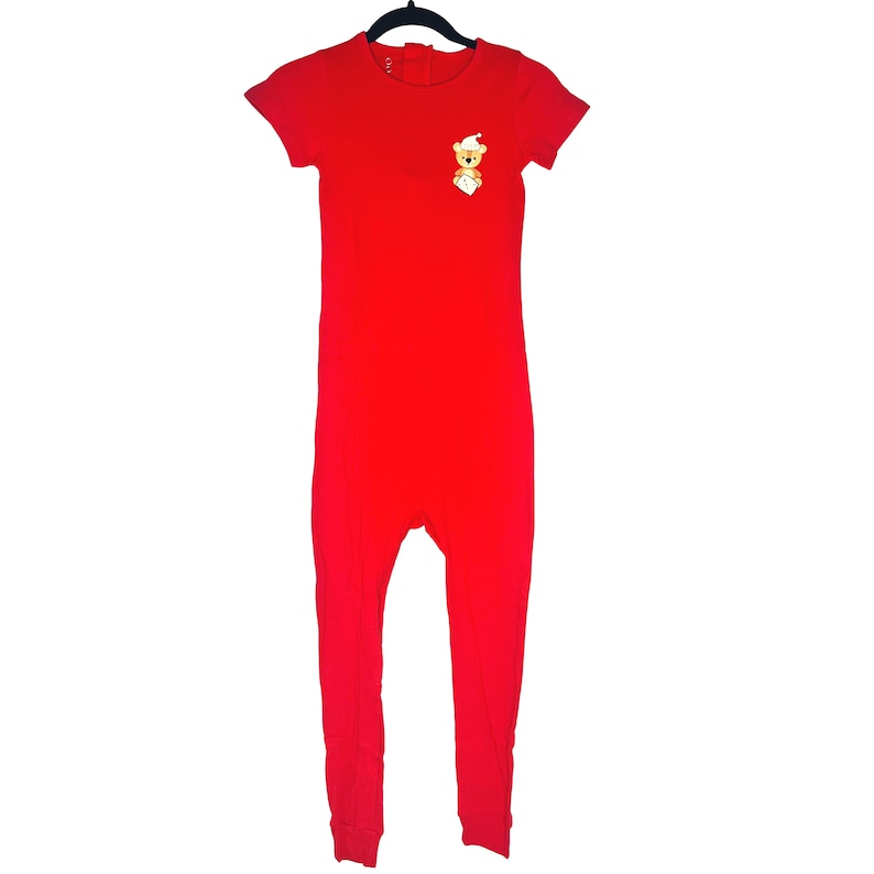 May include: Red short-sleeved jumpsuit with a small embroidered teddy bear on the chest.