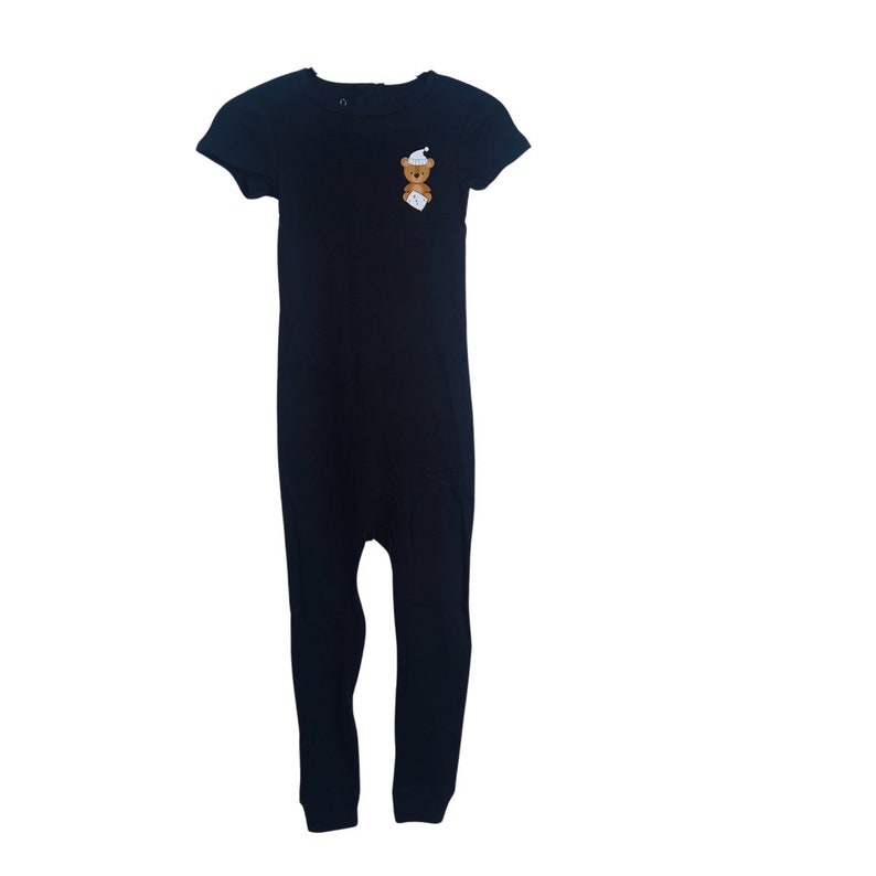May include: Black short-sleeved jumpsuit with a small brown bear wearing a white hat on the front.
