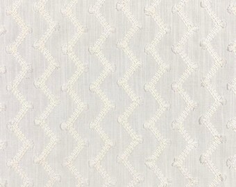 May include: A white fabric featuring a repeating vertical pattern of embroidered zigzag lines. The embroidery consists of small, raised tufted dots placed along the peaks and valleys of each continuous chevron-style stitch design.